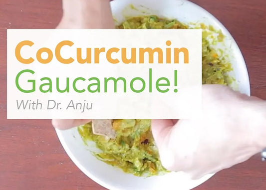 A vibrant bowl of cocurcumin guacamole presented alongside Dr. Anju Sodhi, showcasing a healthy and colorful dish.