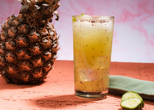 A vibrant pineapple beside a refreshing glow island drink, showcasing a tropical theme and inviting summer vibes