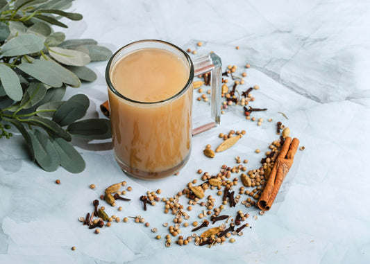 A glass of holy wow chai tea infused with cinnamon and spices, showcasing a warm and inviting beverage.