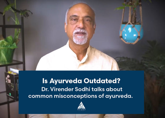 A thoughtful person Dr. Virender Sodhi pondering the relevance of Ayurveda in modern times, surrounded by natural elements and wellness symbols.