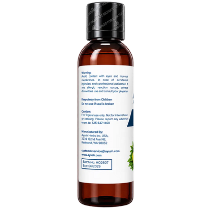All new Ayush Herbs Hair Oil shot from the left side which showcase all the warnings and cautions and also the manufacturing details and the batch number and the expiration date